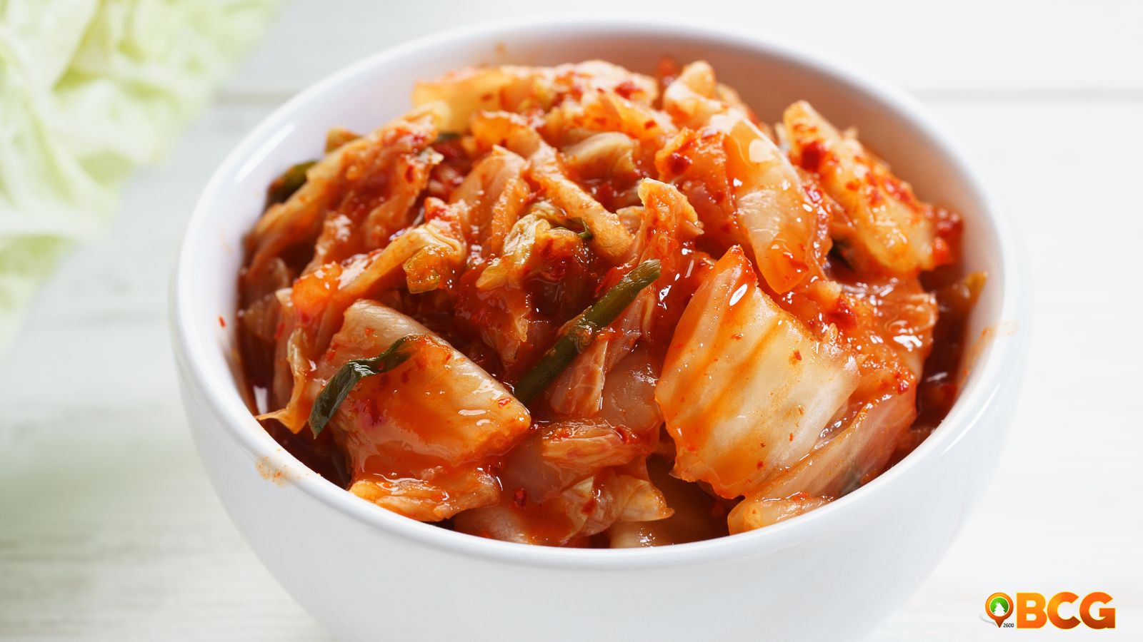 Vibrant cabbage kimchi in a glass jar, showcasing its rich colors and textures, perfect for home cooking.
