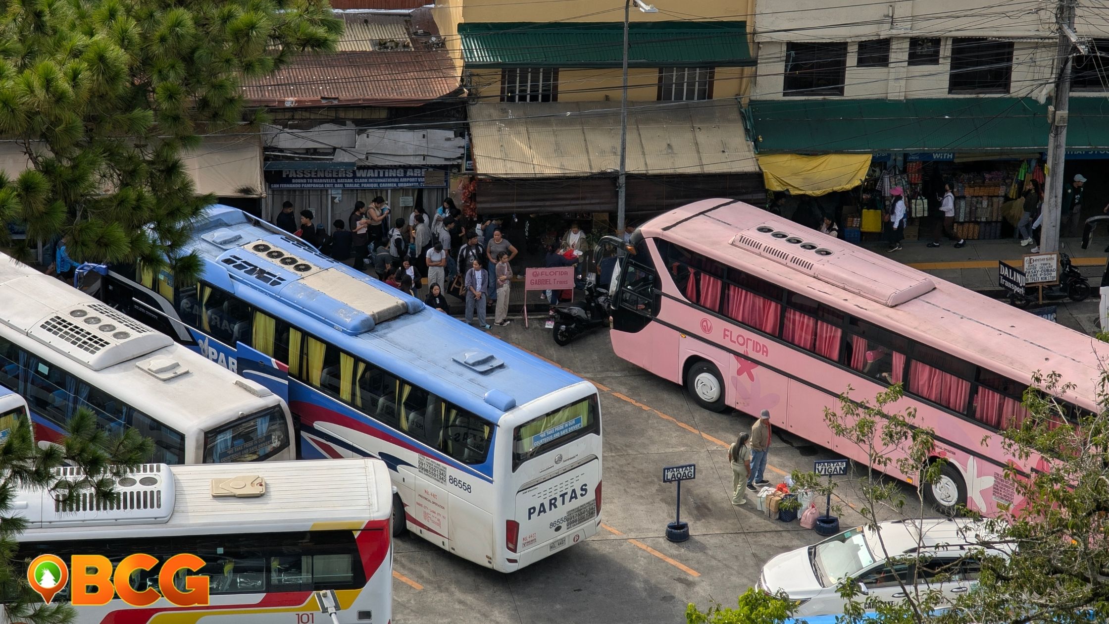 Philippine Rabbit bus terminal at Governor Pack Road, Baguio City, with passengers and buses ready for travel.